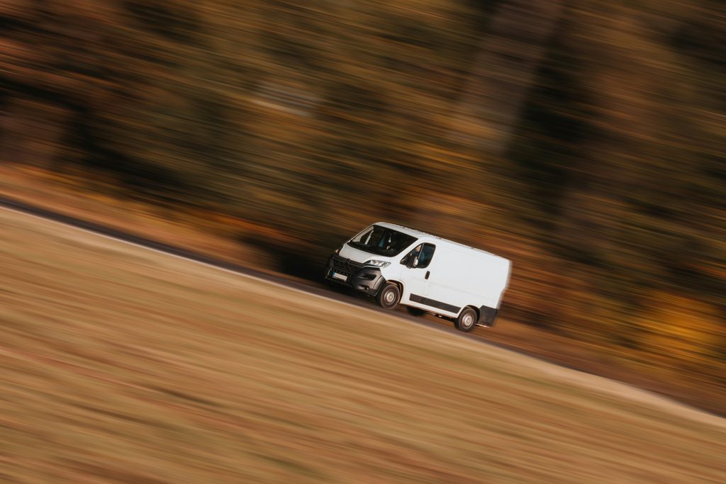 Where to Buy
Deliver van zipping along the road against an autumn forest
